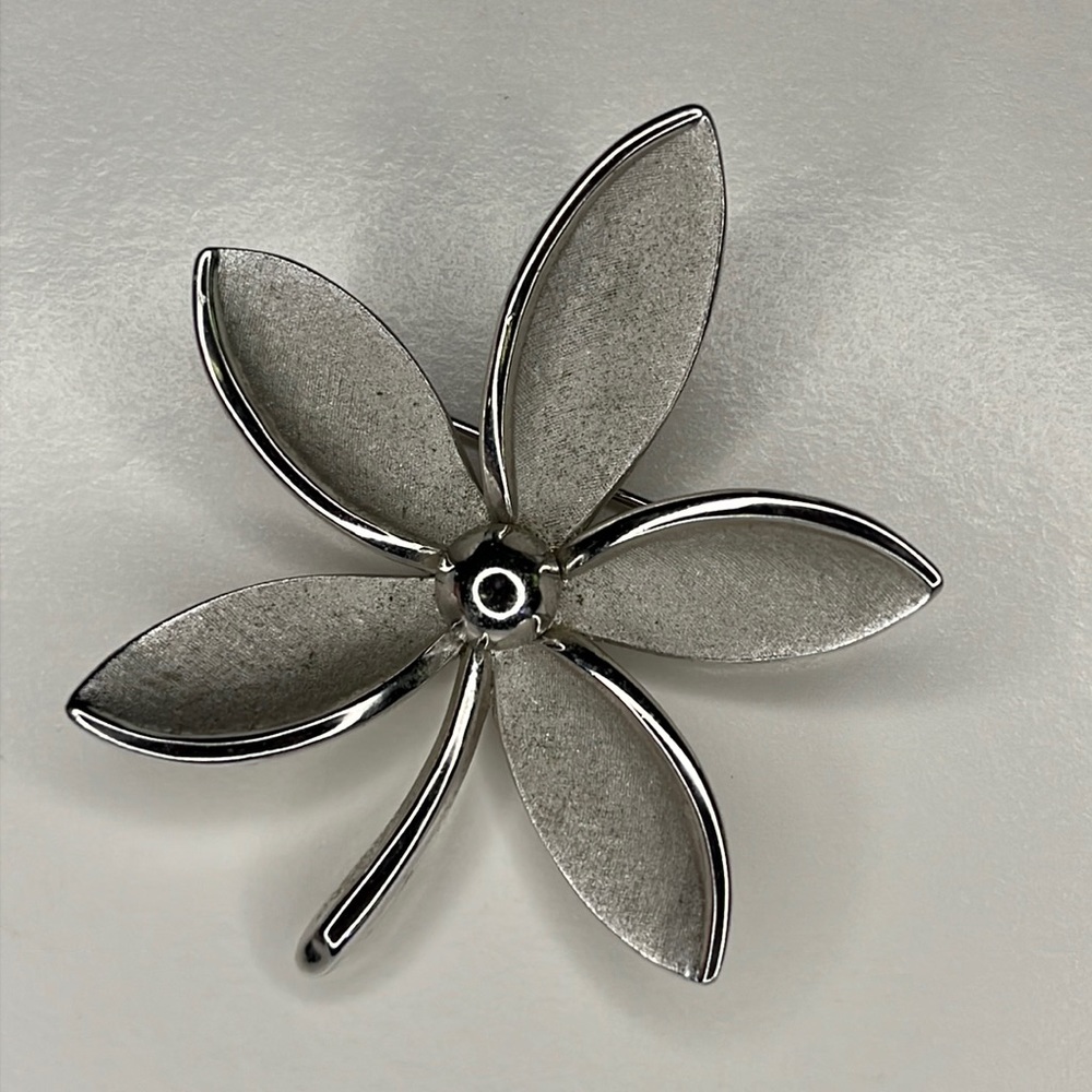 Trifari silver tone flower brooch lapel pin.